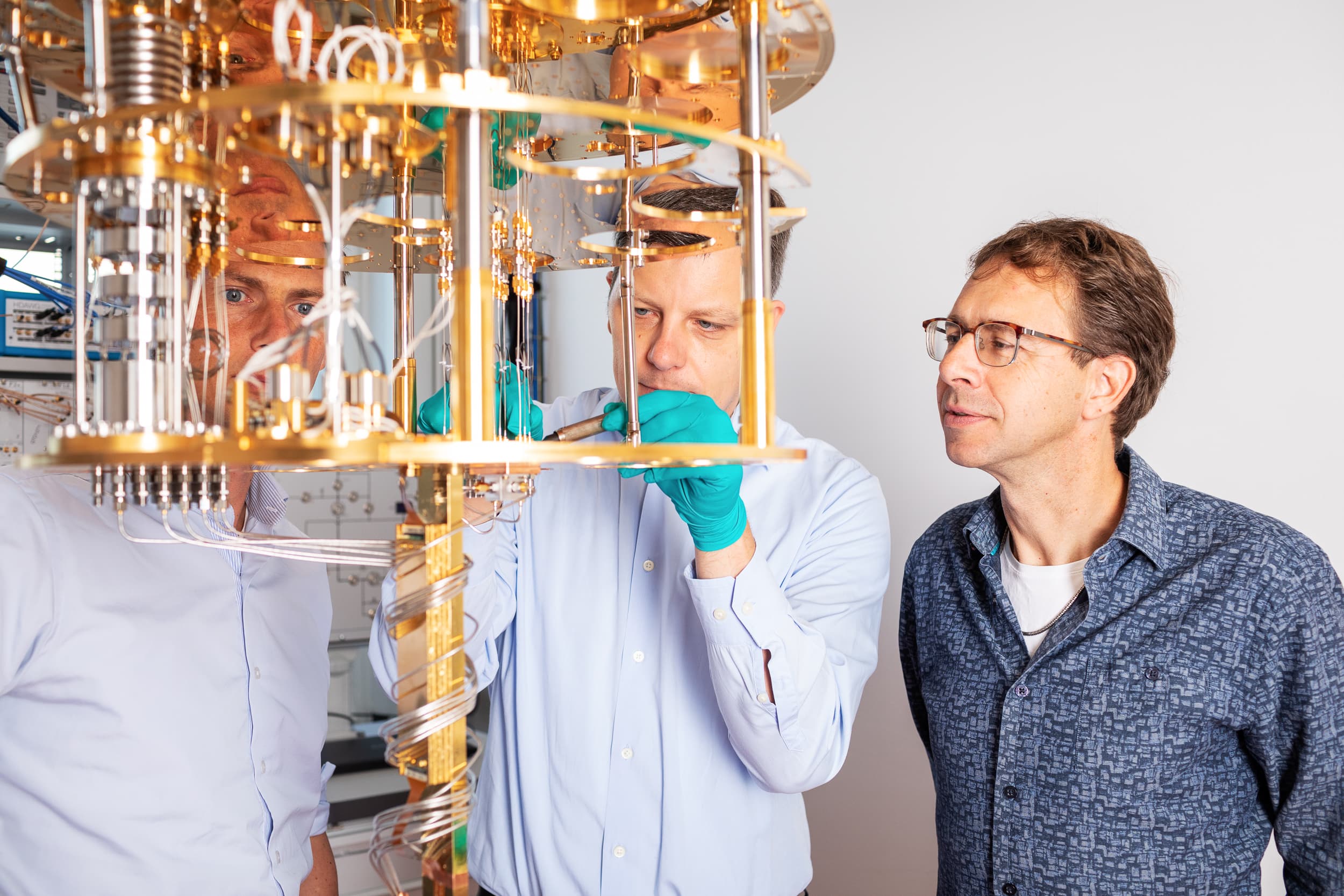 Researchers at QuTech working on a dilution refrigerator that cools quantum processors to 15 millikelvin. Photo: Marieke de Lorijn / QuTech.